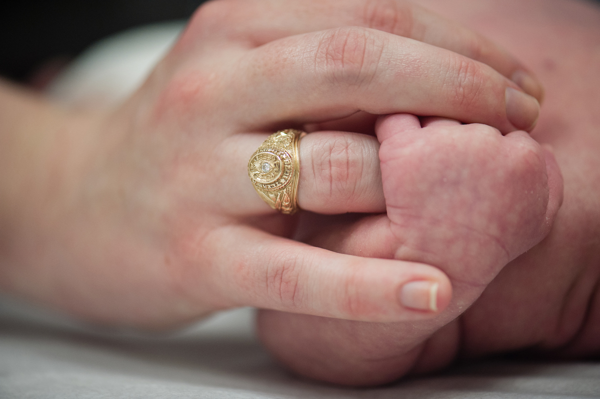 Baby hand wrapped around a finger