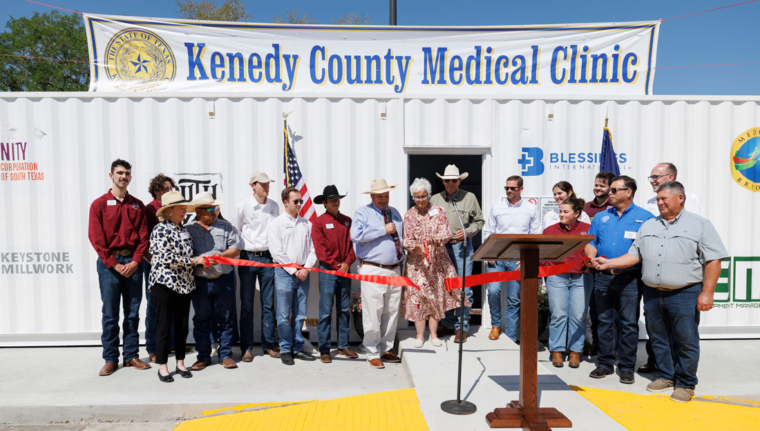 Ribbon cutting of Kenedy County medical clinic container.