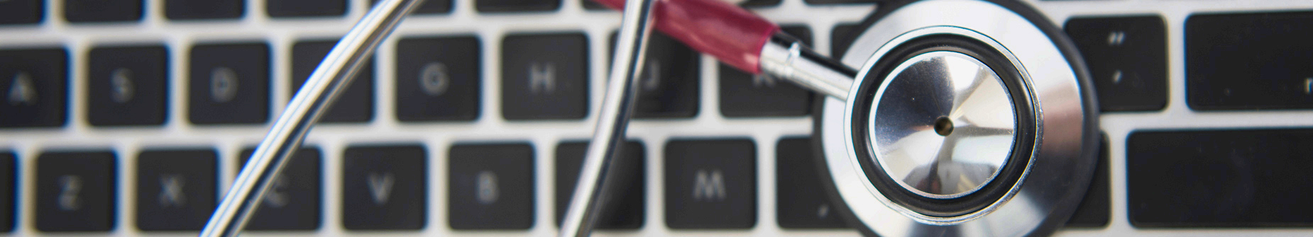 Stethoscope sitting on laptop keyboard