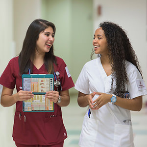 Nursing students walking through a hospital hallway
