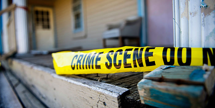 Crime scene tape on the front porch of a house