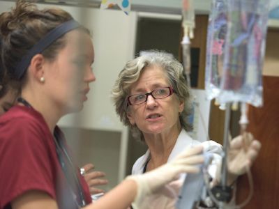 Professor demonstrating medical equipment to a student